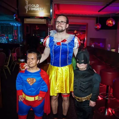 a man and two dwarfs in costumes
