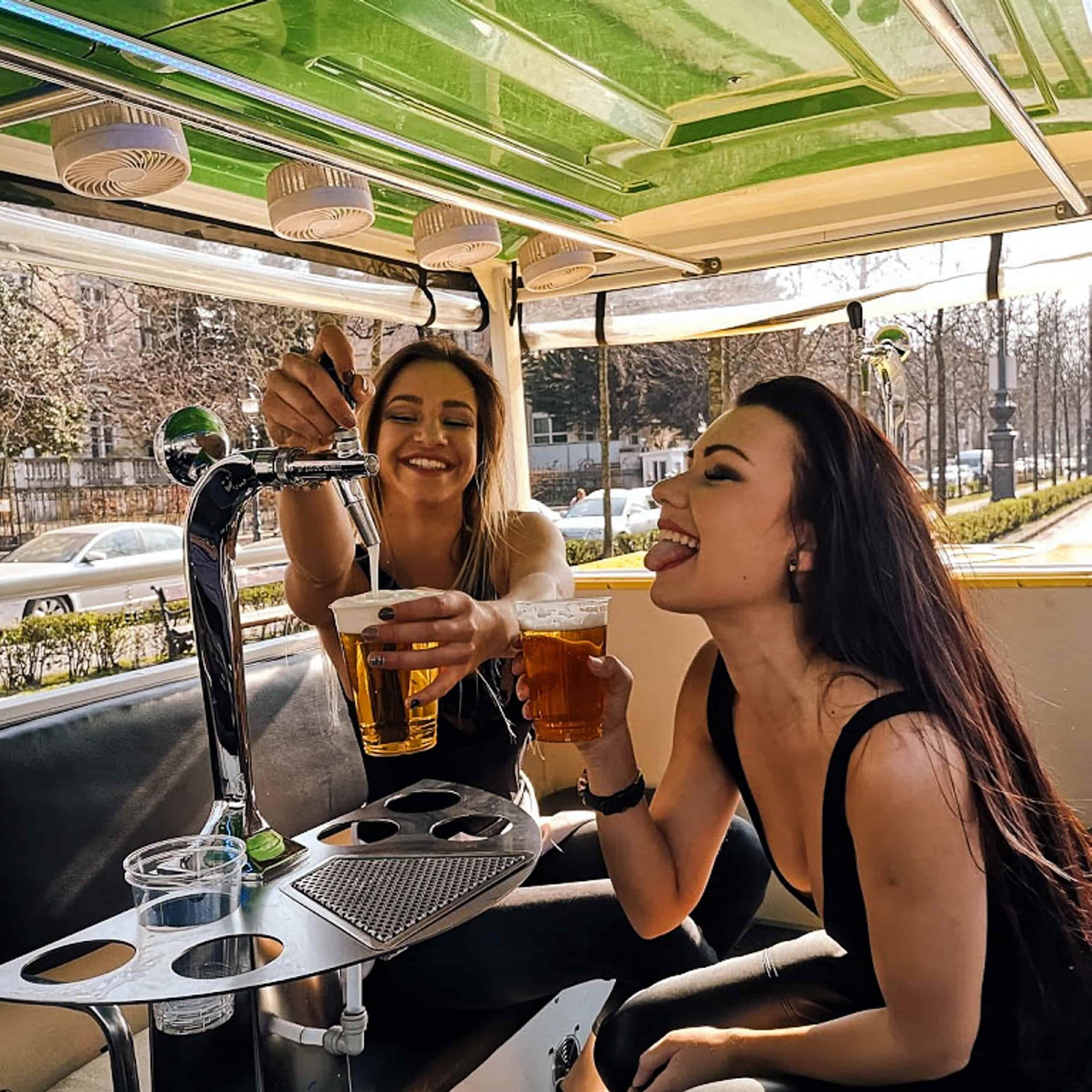 girls enjoying a beer on a beer bus budapest